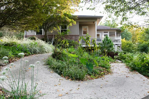 an aerial view of a house with pool yard and outdoor seating