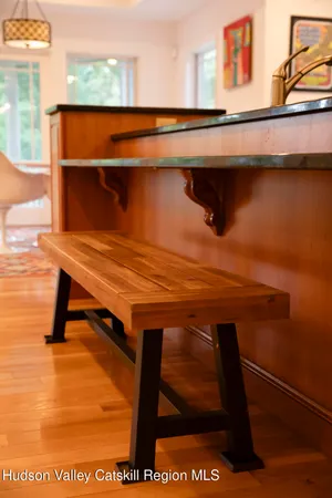 a dining room with wooden floor and a rug