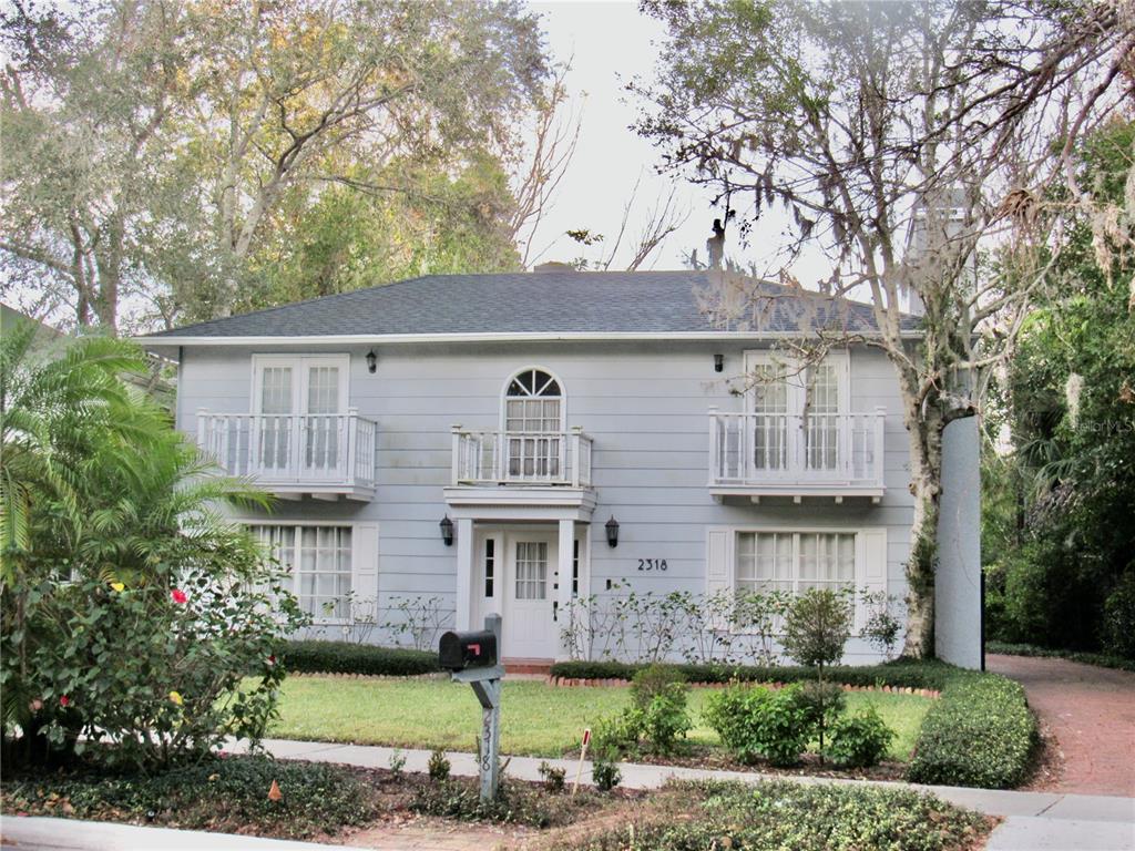 a front view of a house with a garden and plants