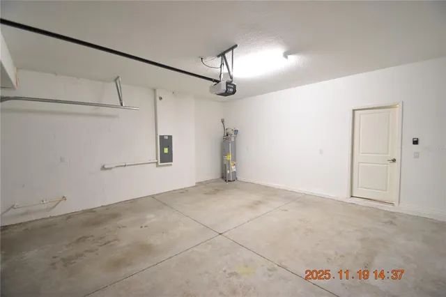 an empty room with a window and a ceiling fan