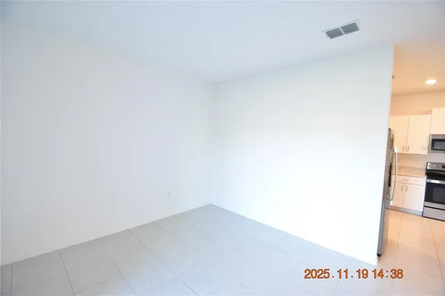 a kitchen with stainless steel appliances a refrigerator and a cabinets