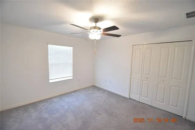 a view of a lake with a yard and furniture