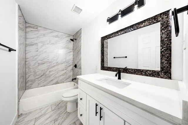 a bathroom with a sink a toilet and a bathtub