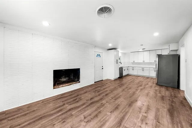 a large kitchen with a stove and a refrigerator