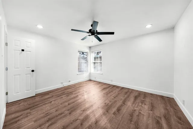 wooden floor in an empty room with a window