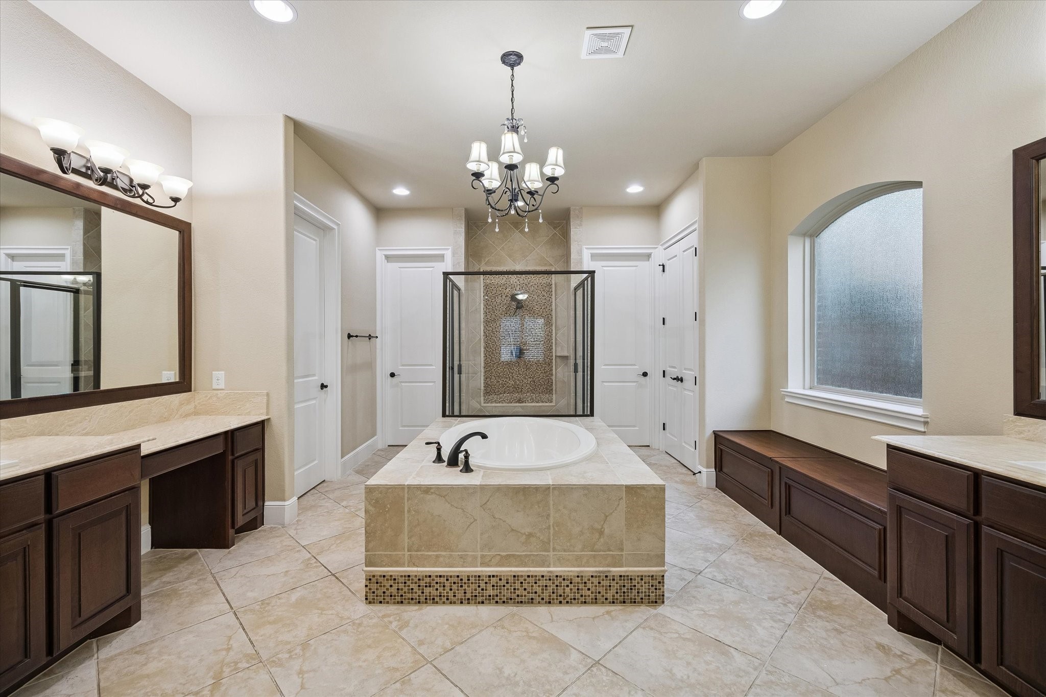 35 North Fremont Ridge Loop Spring, TX 77389 - Photo 14 of 37 The spacious primary en-suite is designed to impress, featuring separate vanities, a relaxing soaking tub, an oversized walk-in shower, extensive storage, and elegant finishes throughout, creating a luxurious spa-inspired retreat.