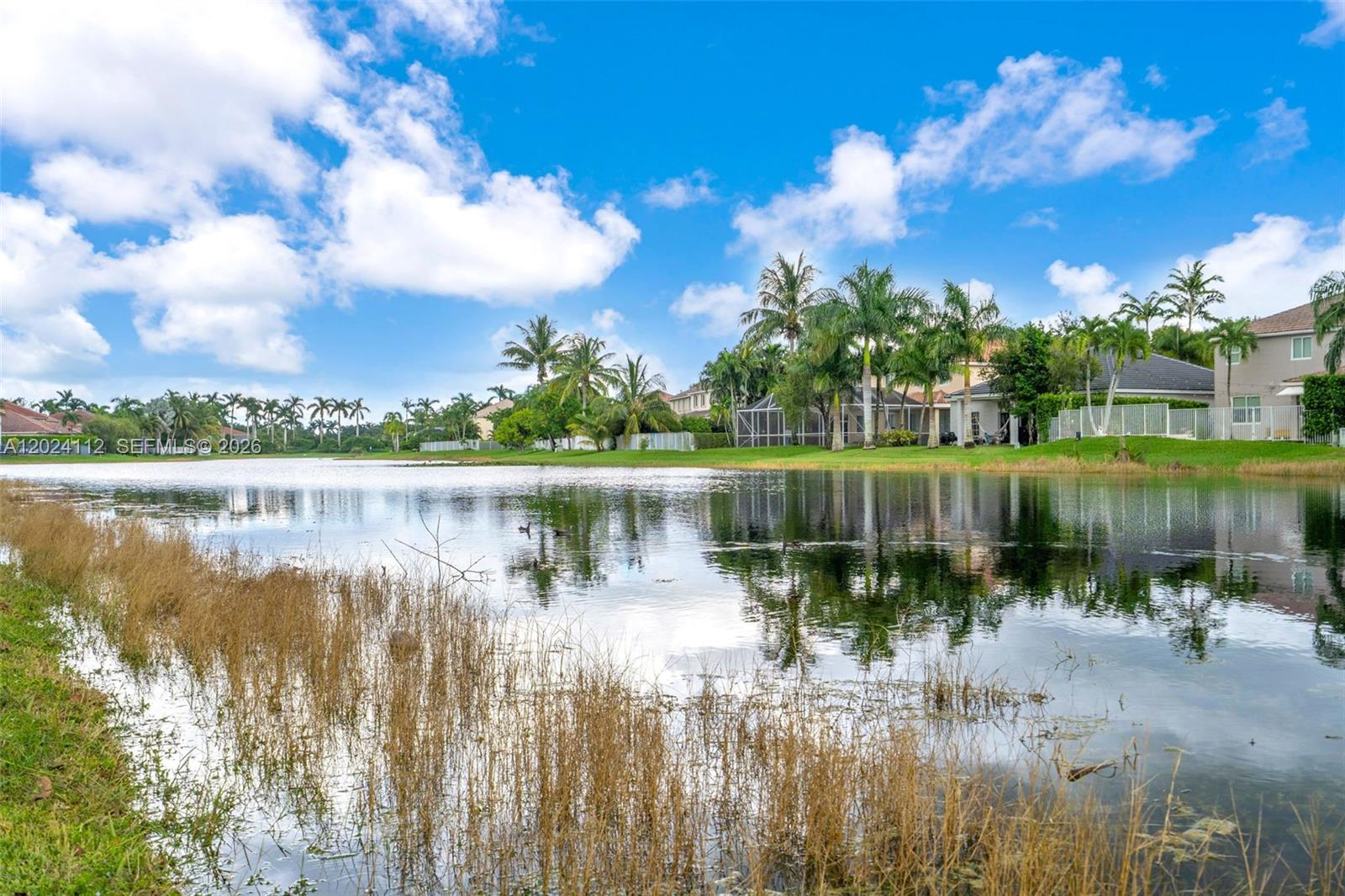 4366 Mahogany Ridge Drive Weston, FL 33331 - Photo 26 of 41 a view of a lake with a big yard