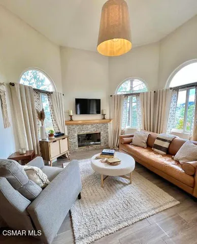 a living room with furniture and a chandelier