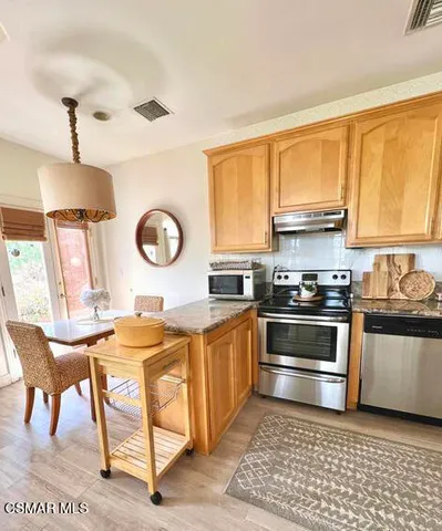 a kitchen with a stove a sink and a refrigerator