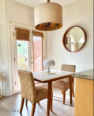 a dining room with furniture and a window