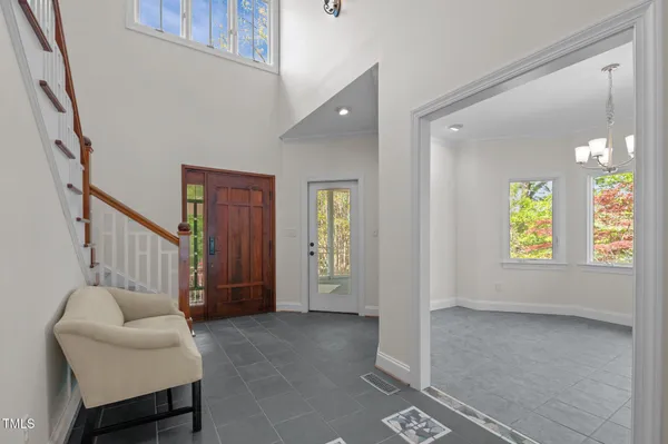 a living room with fireplace furniture flat screen tv and a large window