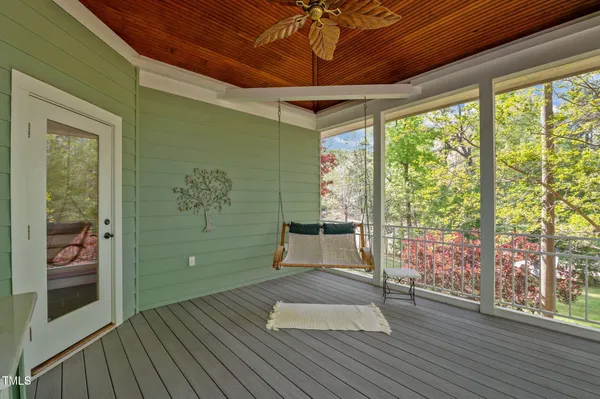 a view of a room that has a large window and front door