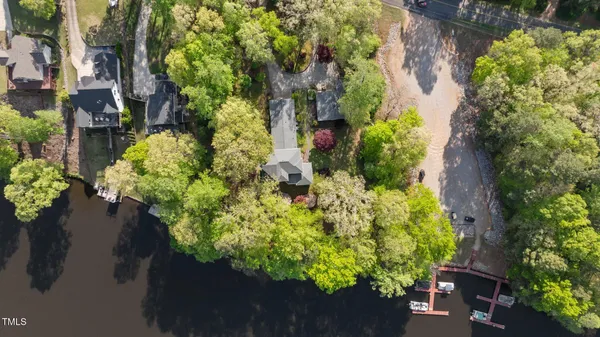 a swimming pool with a yard and trees in the background