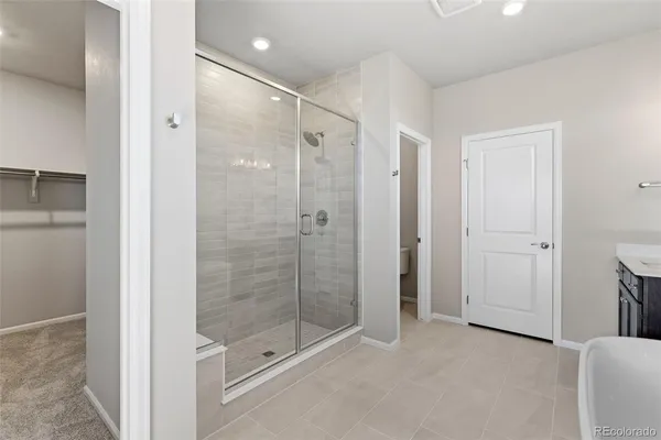 a bathroom with a shower and a glass door