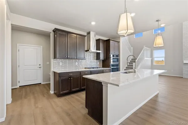 a kitchen with a sink a counter top space and appliances