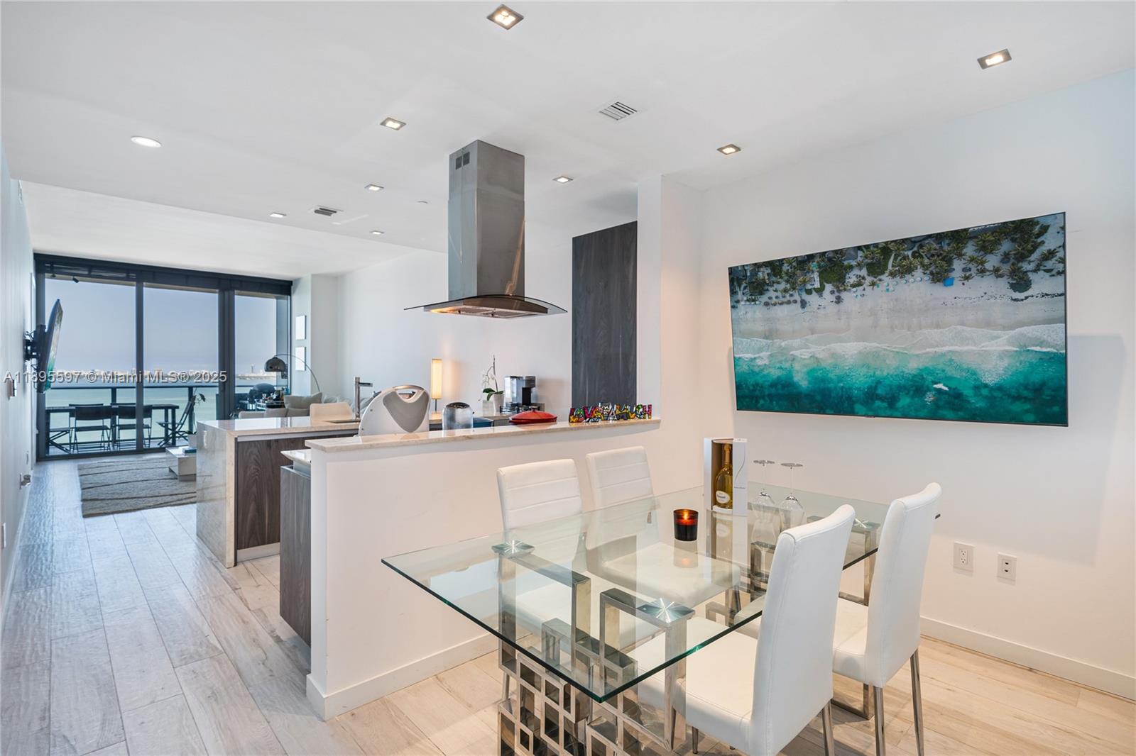 a kitchen with stainless steel appliances kitchen island granite countertop a stove a sink and a refrigerator