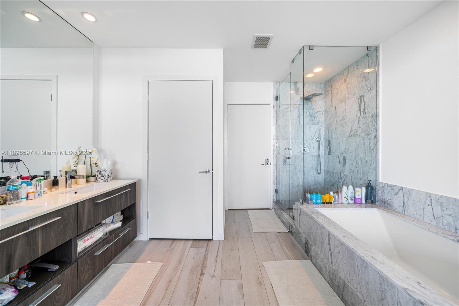 480 Northeast 31st Street, Unit 1603 Miami, FL 33137 - Photo 11 of 14 a bathroom with a tub sink and mirror