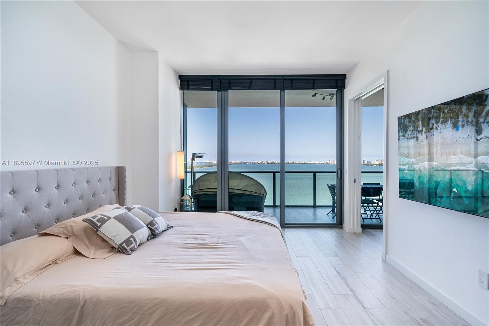 480 Northeast 31st Street, Unit 1603 Miami, FL 33137 - Photo 4 of 14 a bedroom with a bed and a large window