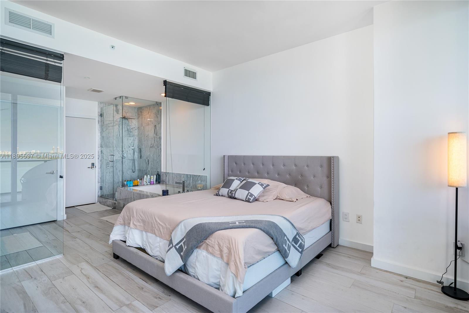 480 Northeast 31st Street, Unit 1603 Miami, FL 33137 - Photo 9 of 14 a bedroom with a bed and a table