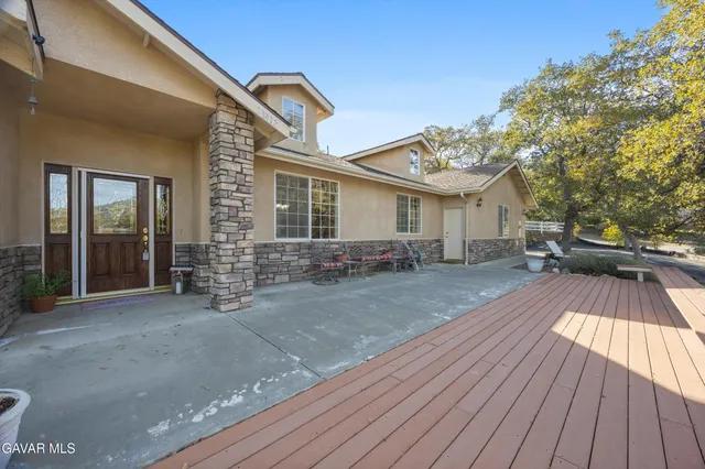 a living room with furniture a fireplace and a potted plant