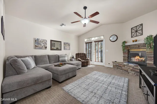 a living room with furniture and a fireplace