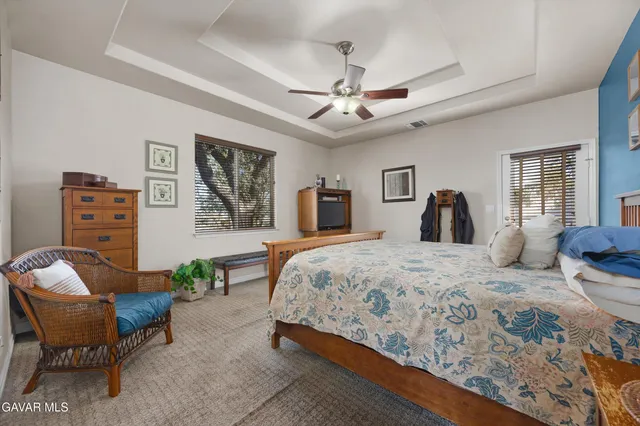 a bedroom with a bed couch and a window