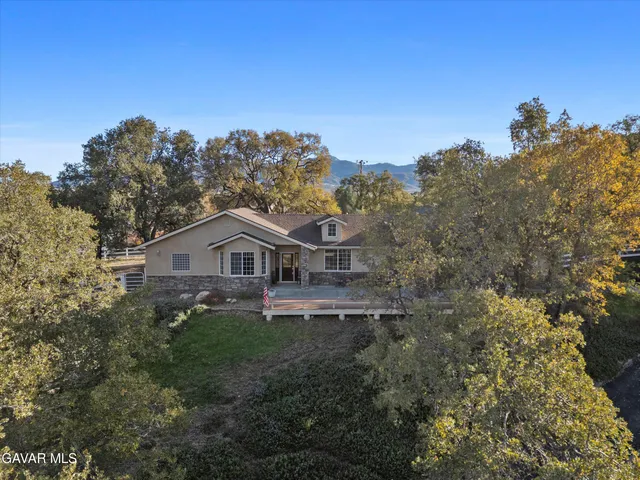 an aerial view of a house with mountain view