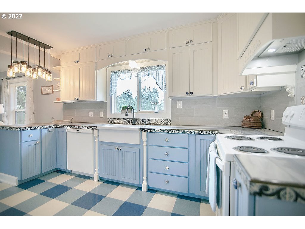 121 Rarey Road Winlock, WA 98596 - Photo 11 of 32 a kitchen with a stove a sink and a window