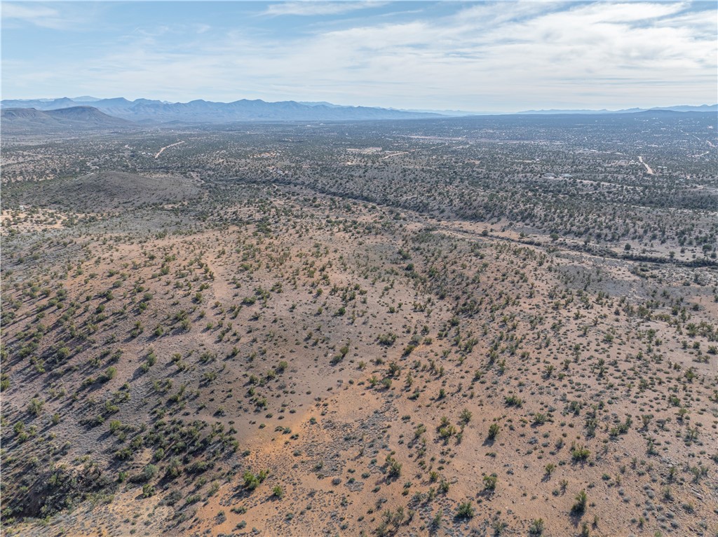 3207 Stetson Road Kingman, AZ 86401 - Photo 10 of 11 Aerial view of sparsely populated area featuring a mountain backdrop