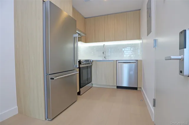 a bathroom with a double vanity sink a toilet and shower
