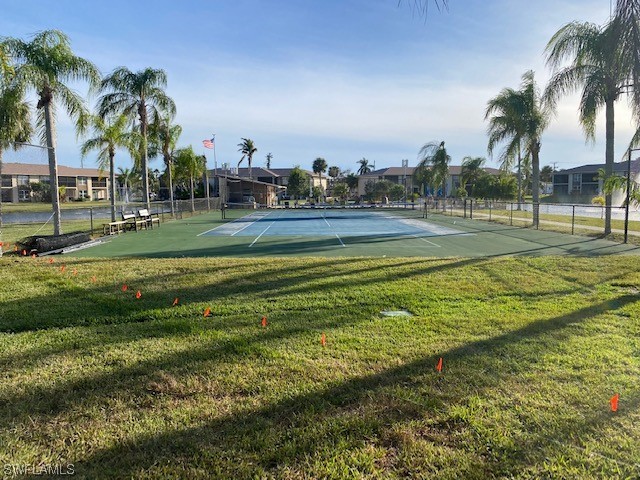 16007 Davis Road, Unit 515 Fort Myers, FL 33908 - Photo 14 of 14 a view of a swimming pool with a yard and a palm tree