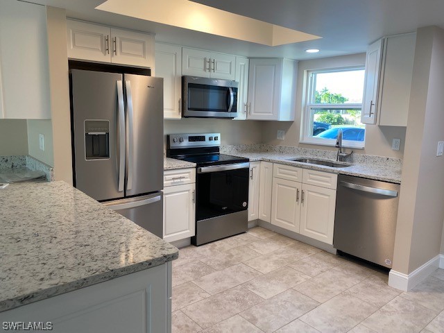 16007 Davis Road, Unit 515 Fort Myers, FL 33908 - Photo 2 of 14 a kitchen with a sink stove and refrigerator