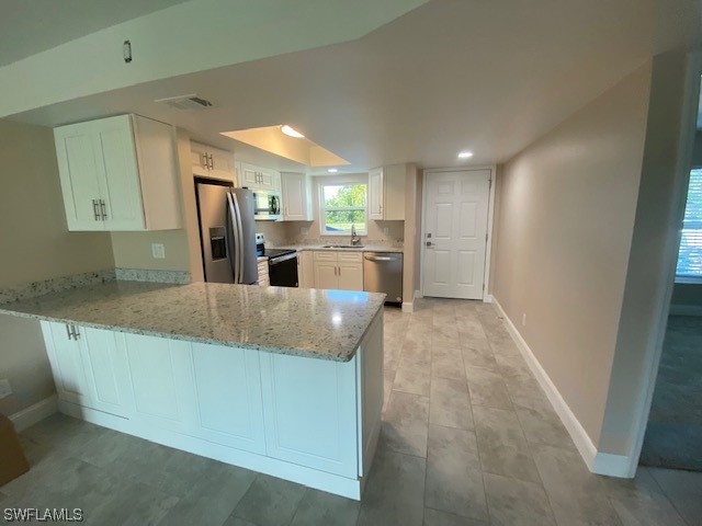 16007 Davis Road, Unit 515 Fort Myers, FL 33908 - Photo 3 of 14 a large kitchen with stainless steel appliances kitchen island granite countertop a refrigerator a sink a stove and island