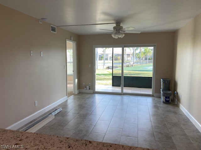 16007 Davis Road, Unit 515 Fort Myers, FL 33908 - Photo 6 of 14 an empty room with wooden floor and windows