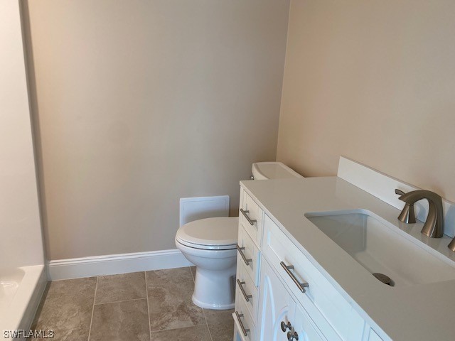 16007 Davis Road, Unit 515 Fort Myers, FL 33908 - Photo 9 of 14 a white toilet sitting next to a bathroom sink