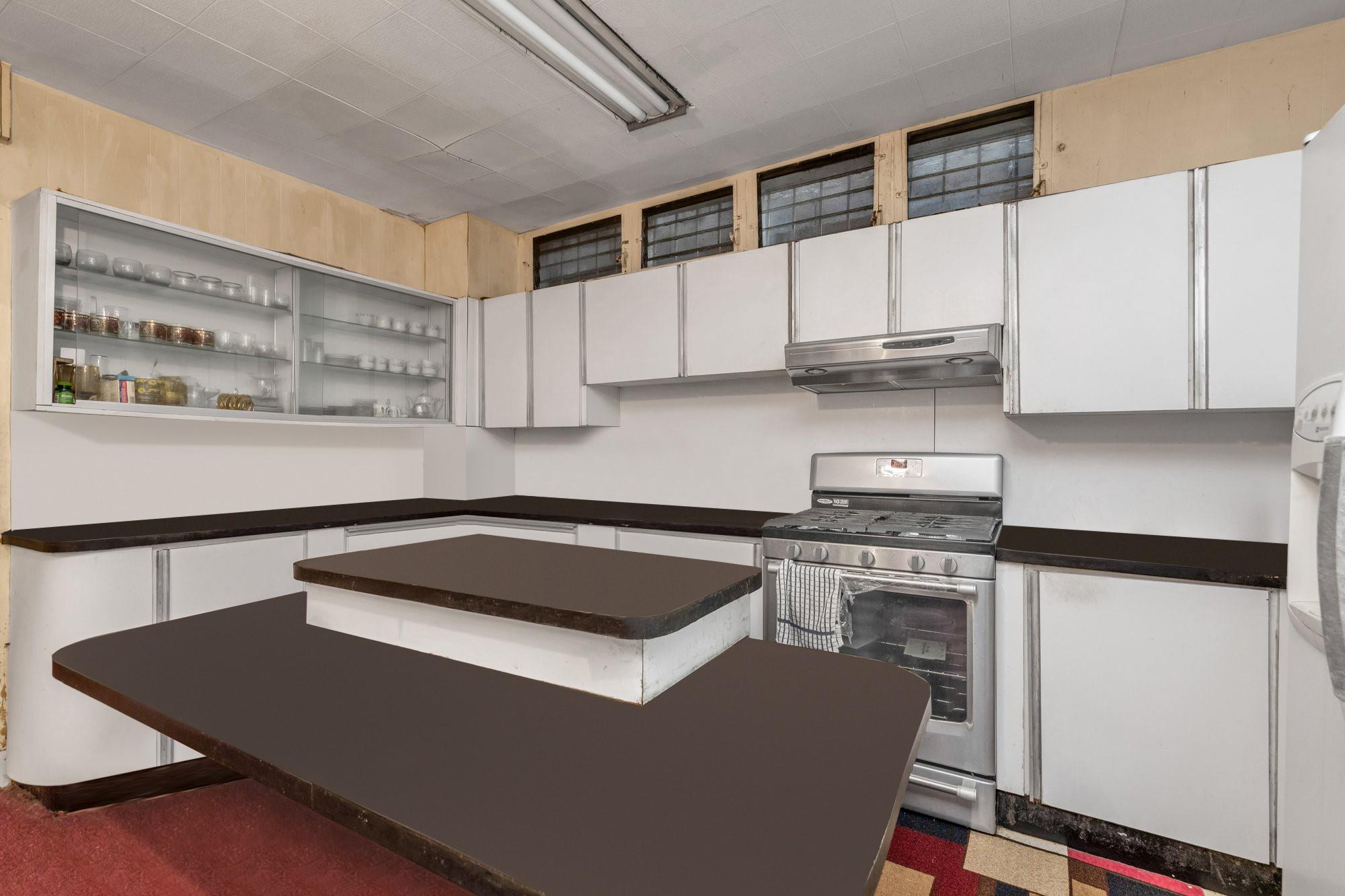 112-50 38th Avenue Queens, NY 11368 - Photo 11 of 17 a kitchen with stainless steel appliances a stove a sink and a refrigerator