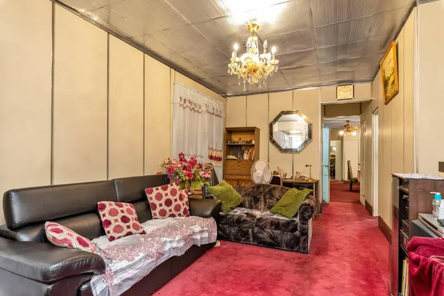 a living room with furniture chandelier and a chandelier
