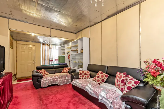 a living room with furniture and flowers