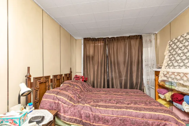 a bed sitting in a bedroom next to a window