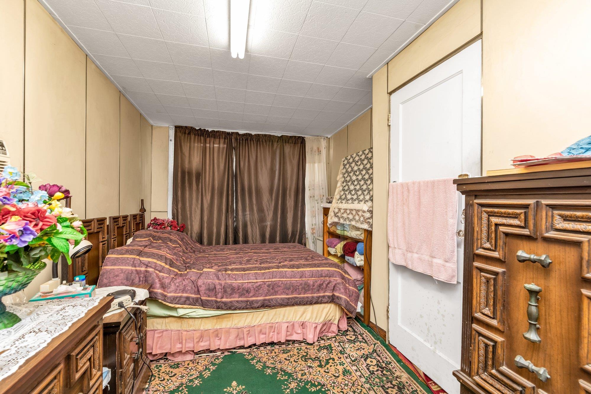 112-50 38th Avenue Queens, NY 11368 - Photo 6 of 17 a bedroom with a bed and a window