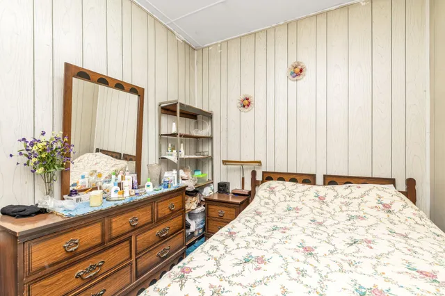 a large bedroom with bed and window