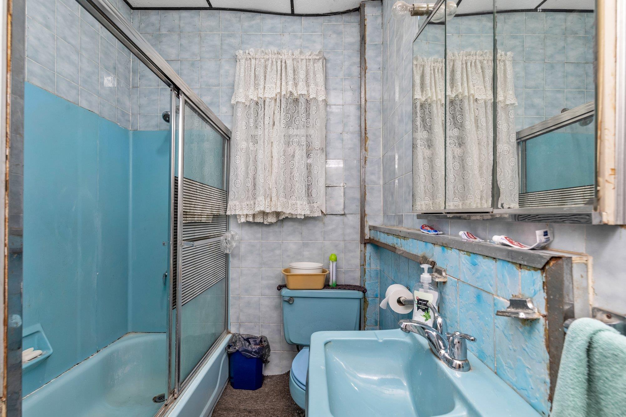 112-50 38th Avenue Queens, NY 11368 - Photo 8 of 17 a bathroom with a sink a toilet and tub