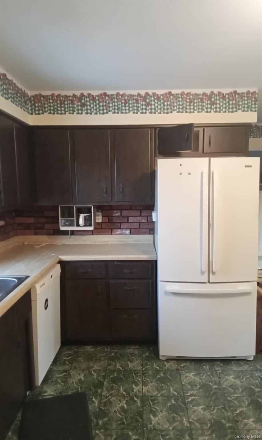 88 Barnes Road Blooming Grove, NY 10992 - Photo 4 of 12 Kitchen with dark brown cabinets, white appliances, and light countertops