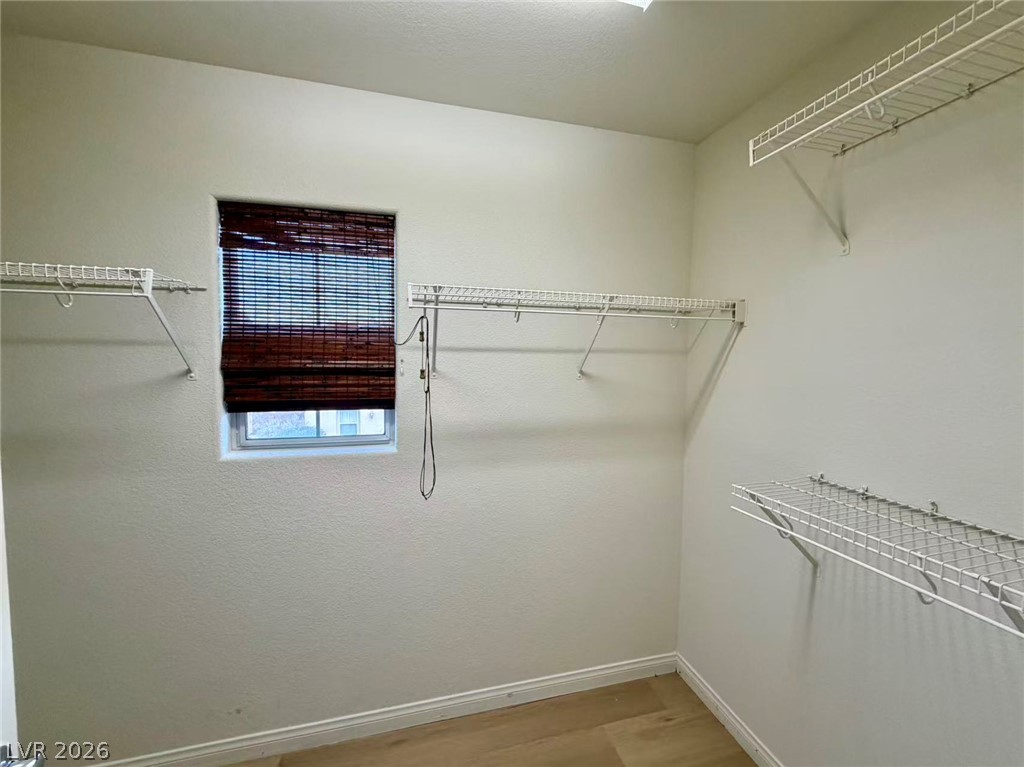11183 Ranch Valley Street Las Vegas, NV 89179 - Photo 10 of 19 Ample shelving in this naturally lit walk-in closet offers extensive storage solutions.