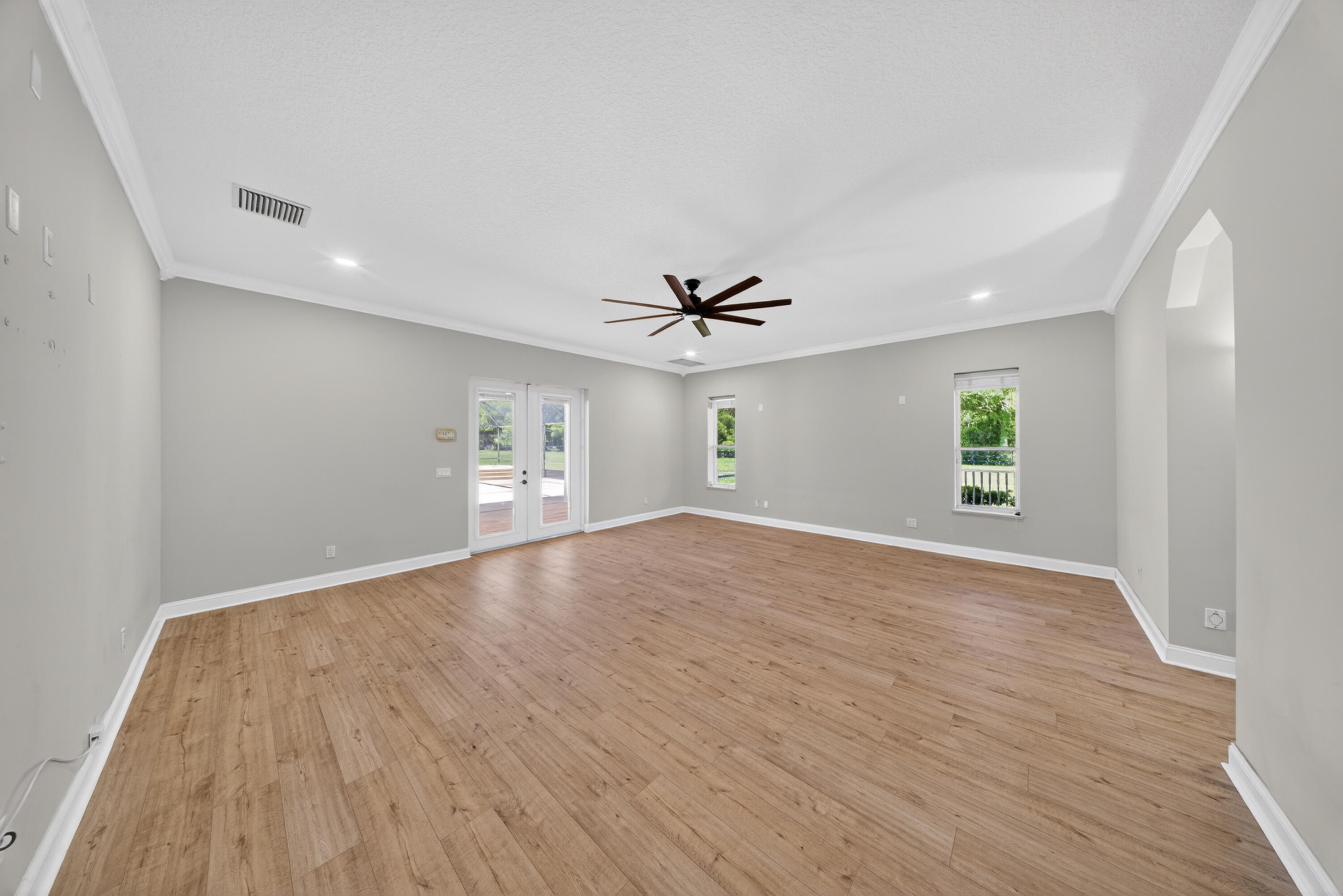 8686 Andrews Avenue Fort Pierce, FL 34945 - Photo 23 of 76 wooden floor in an empty room with a window
