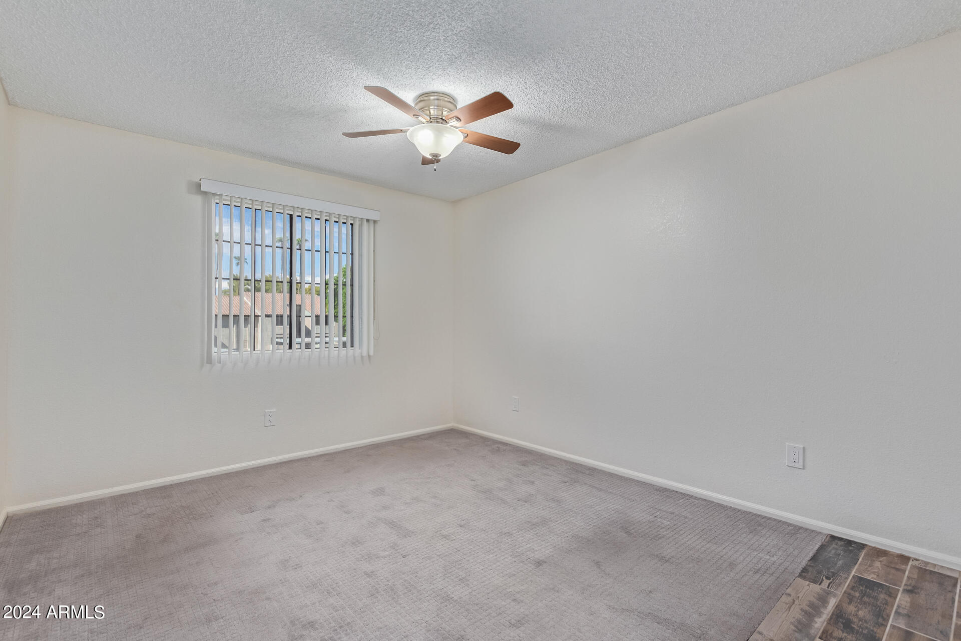 533 West Guadalupe Road, Unit 2046 Mesa, AZ 85210 - Photo 13 of 29 an empty room with windows and chandelier fan