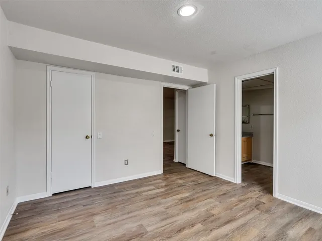 a view of an empty room and wooden floor