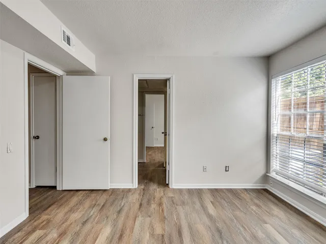 a view of a room with wooden floor and window