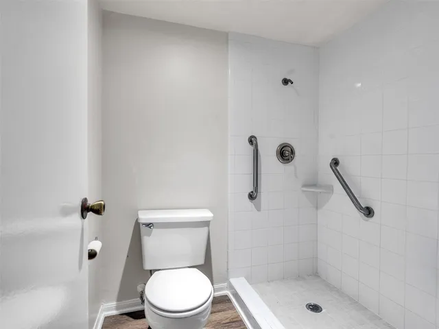 a white toilet sitting next to a bathroom