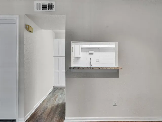 a view of a small space with wooden floor